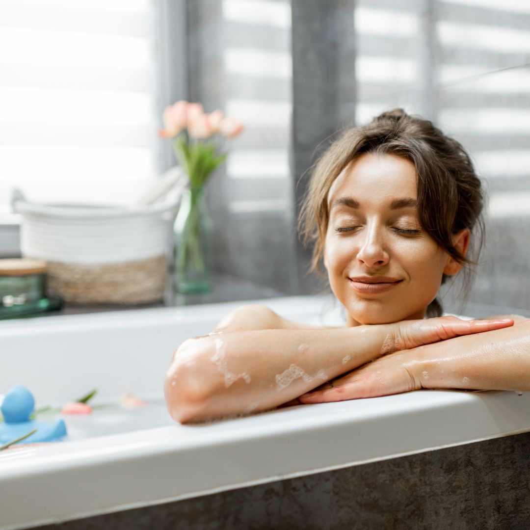 women smiling in tub so many benefits of a hot bath