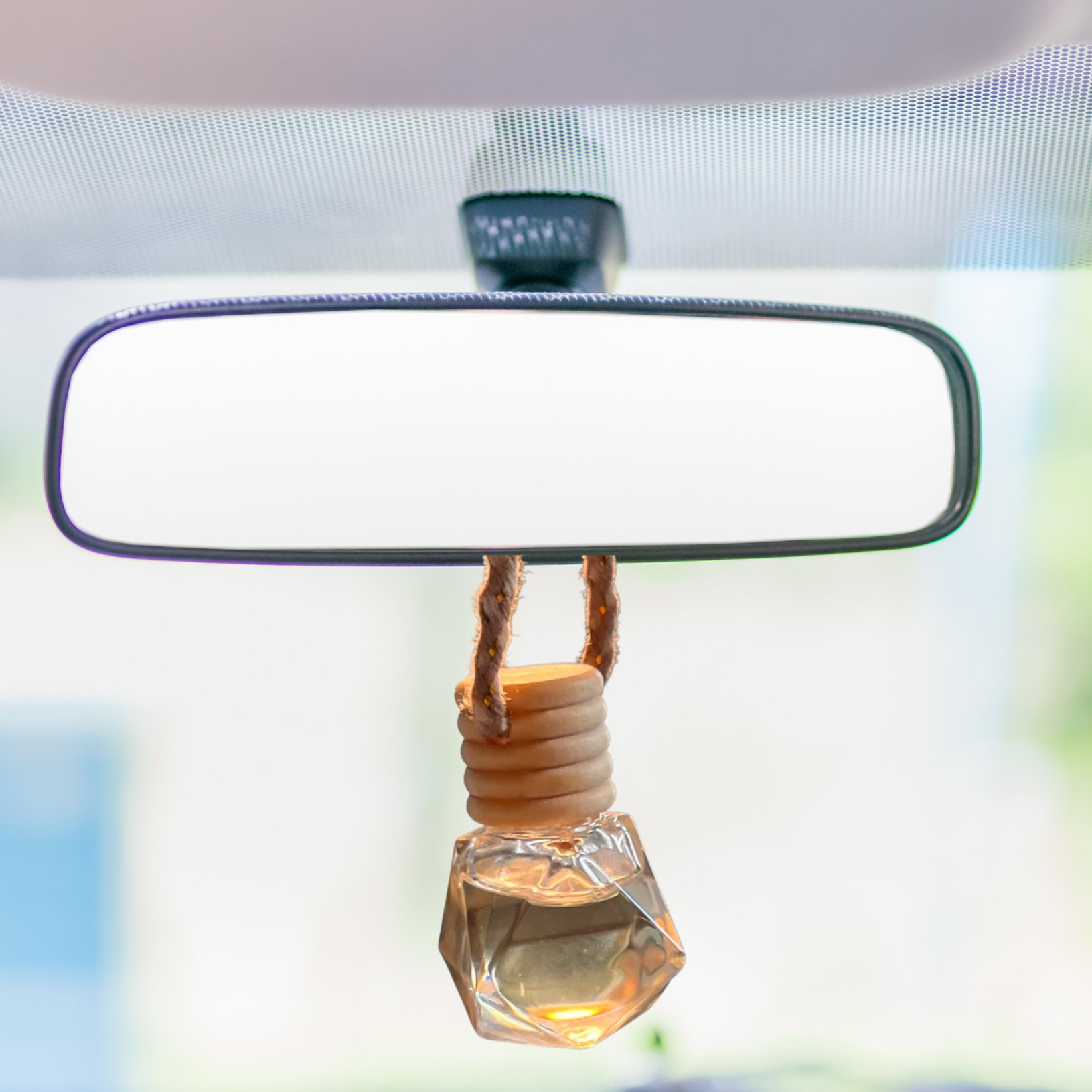 car air freshener diffuser to hang from rearview. a tiny rope, attaches a tiny glass jar filled with pure essenTIAL OIL