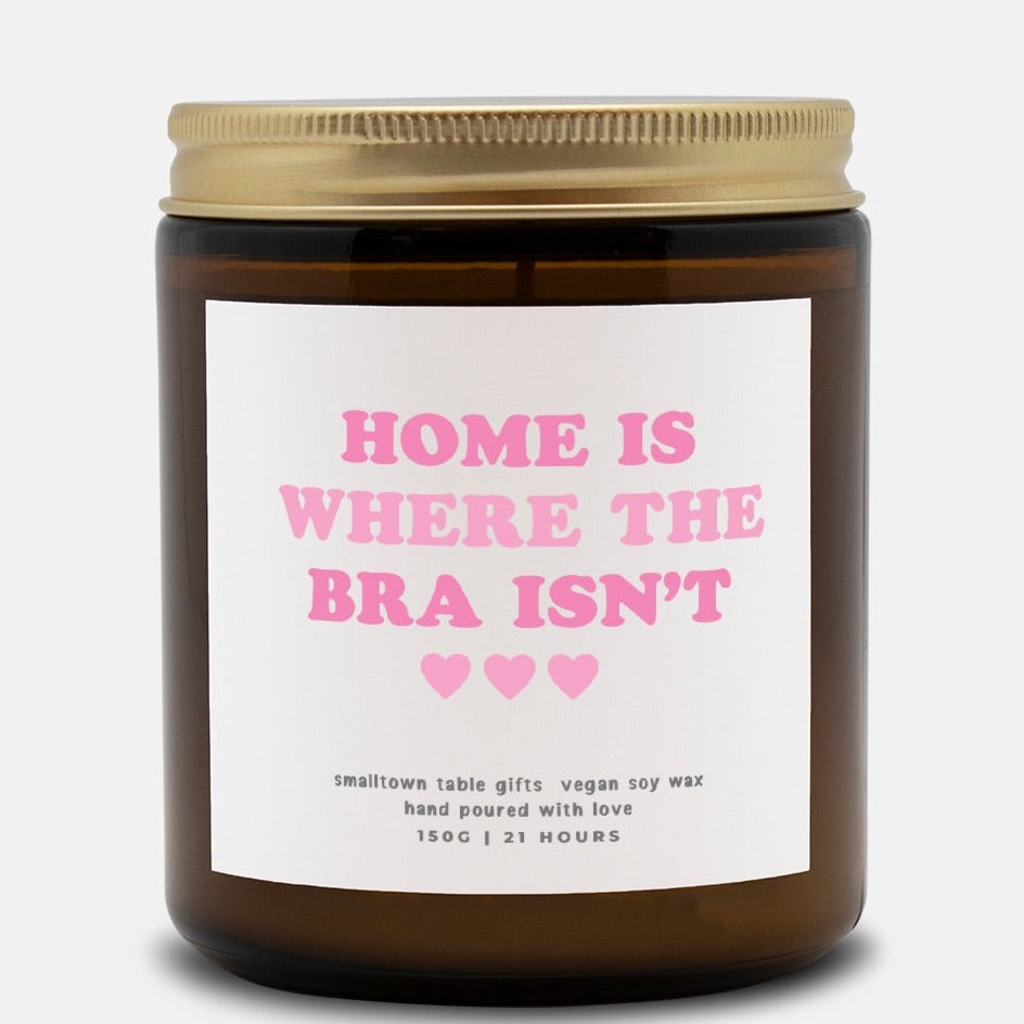 home is where the bra isn;t label on amber glass jar candle and gold lid