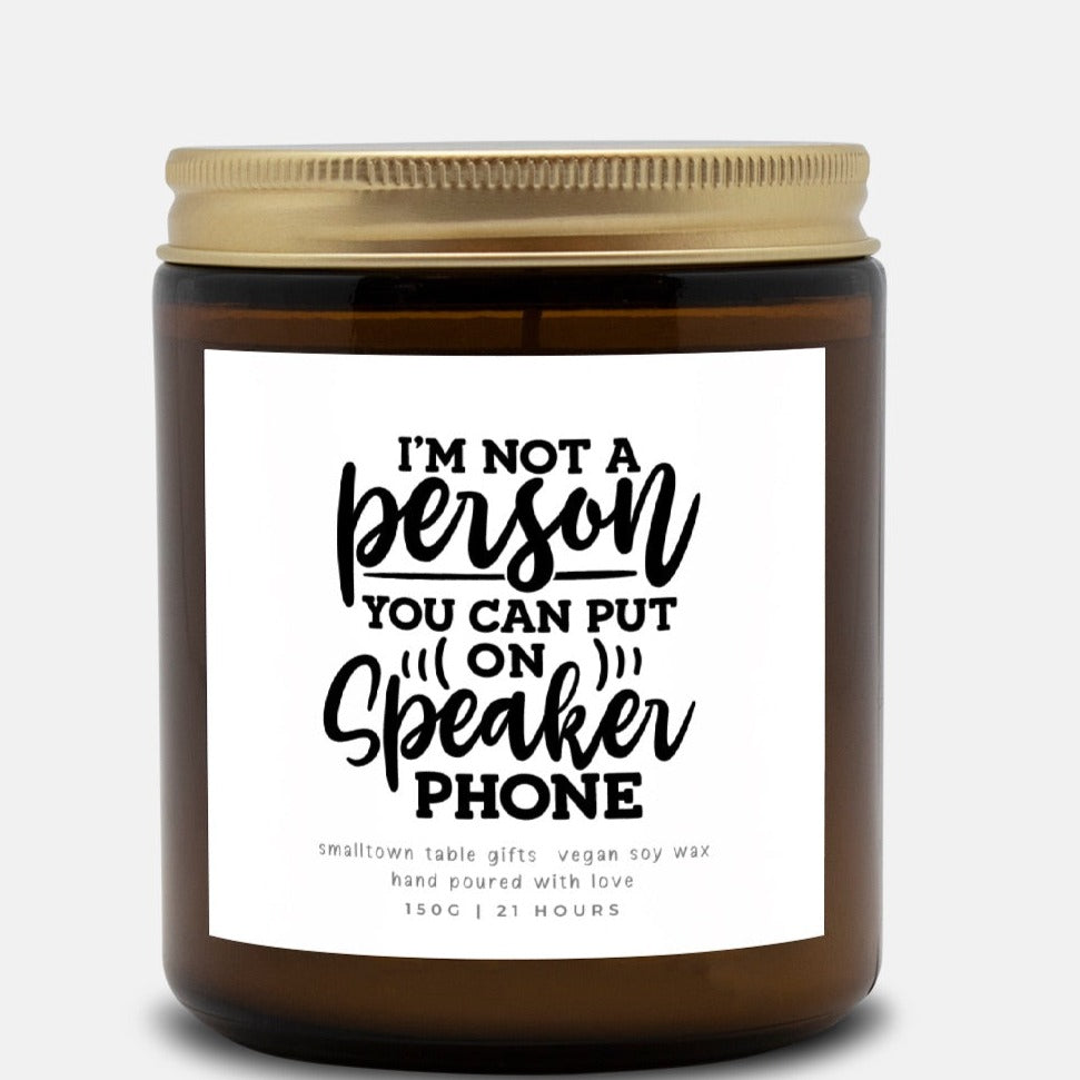 amber glass jar candle with label that says I am ot a person you can put on speaker phone